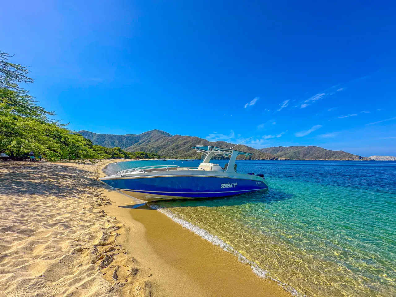 Serenity's boat on the golden sandy shore of Bahía Concha