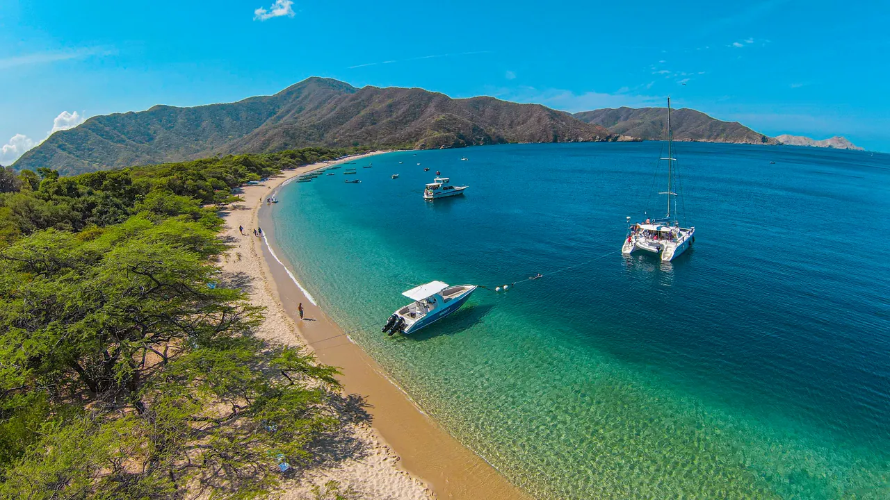 Crystal-clear water lapping against the sand on the shore of Bahía Concha.