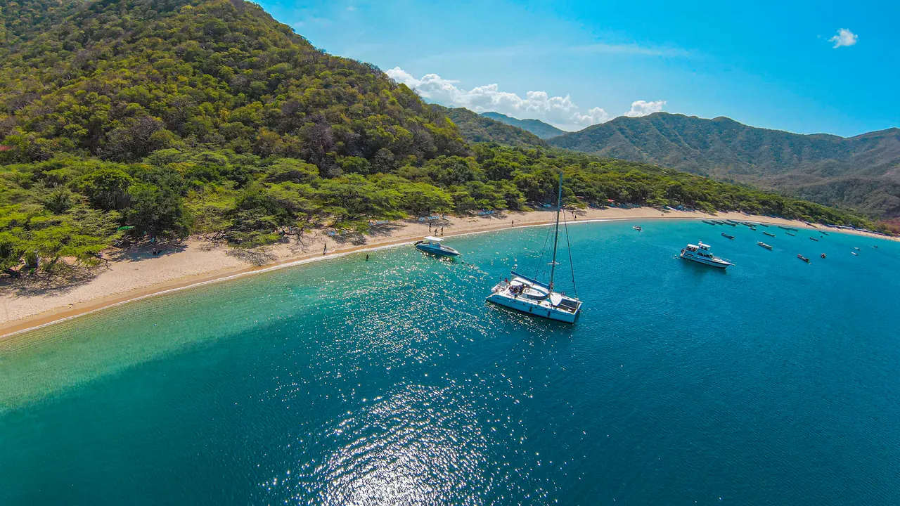 Bahía Concha, seen from the sea, with dry tropical forest on the hillsides.