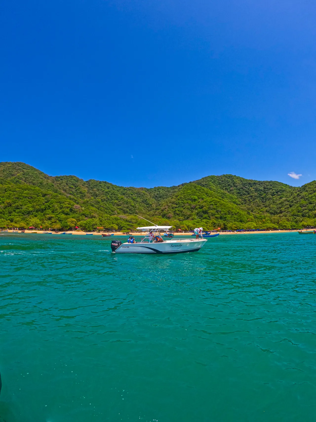 A boat sailing off the hills of Playa Cristal.