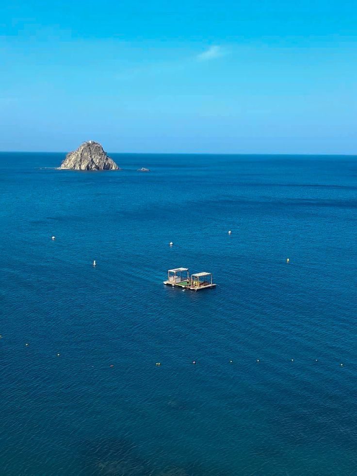 Turquoise sea with a small island near Inca Inca