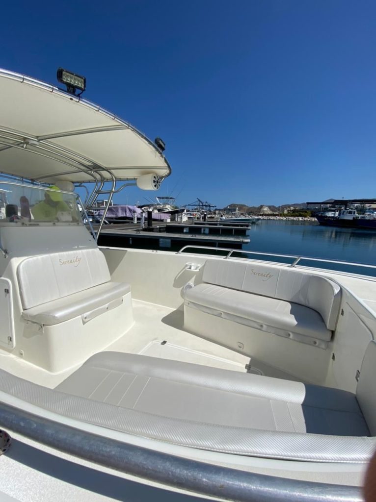 Padded seats under the boat's awning.