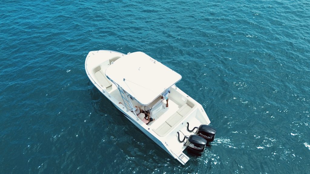 Aerial view of the boat in turquoise waters near Cinto.