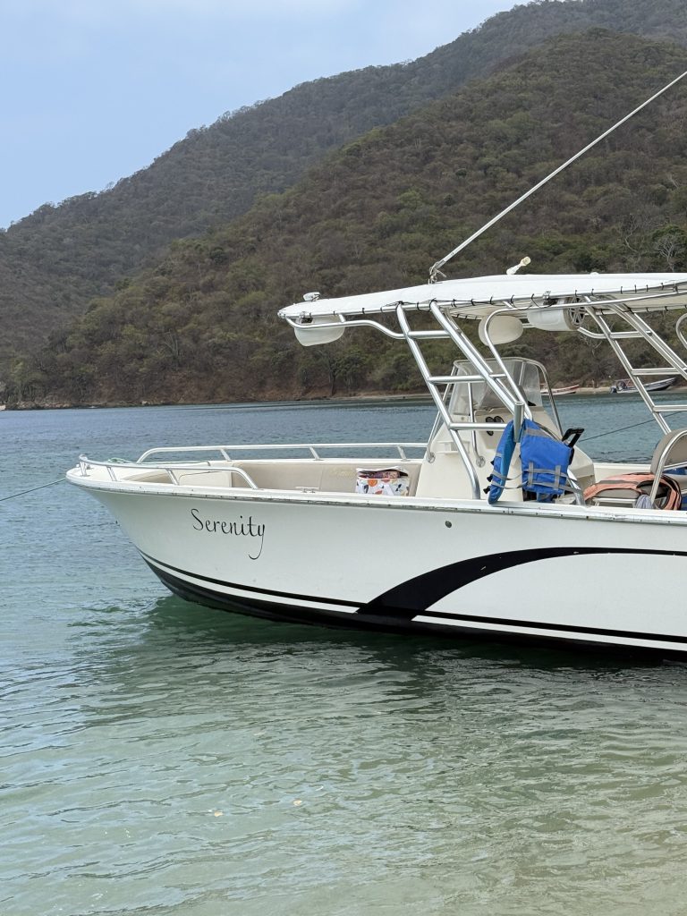 A boat anchored off the shore of Cinto.