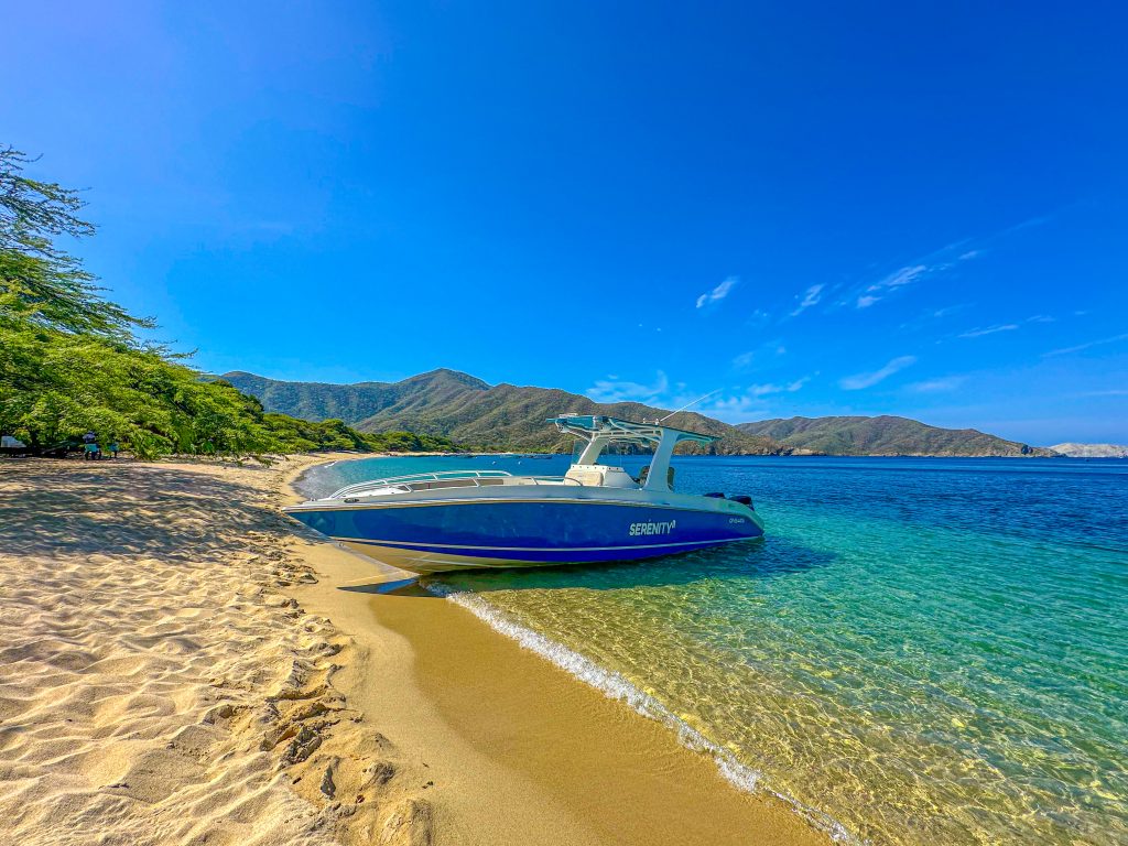 Serenity's boat on the golden shore of Bahía Concha