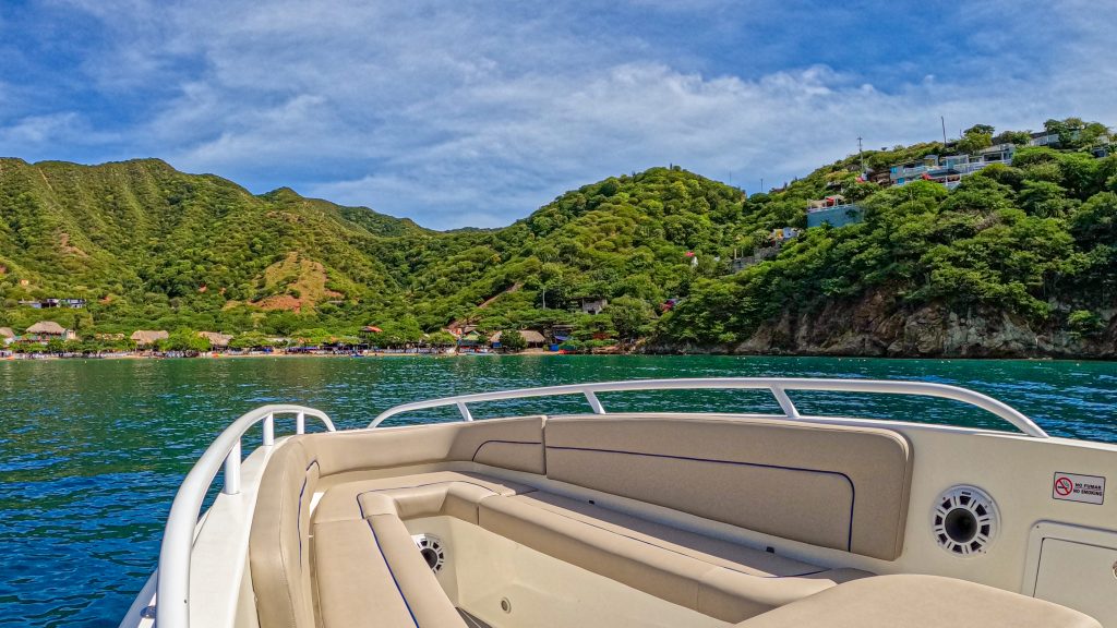 The bow of the boat off the green coastline of Playa Grande.